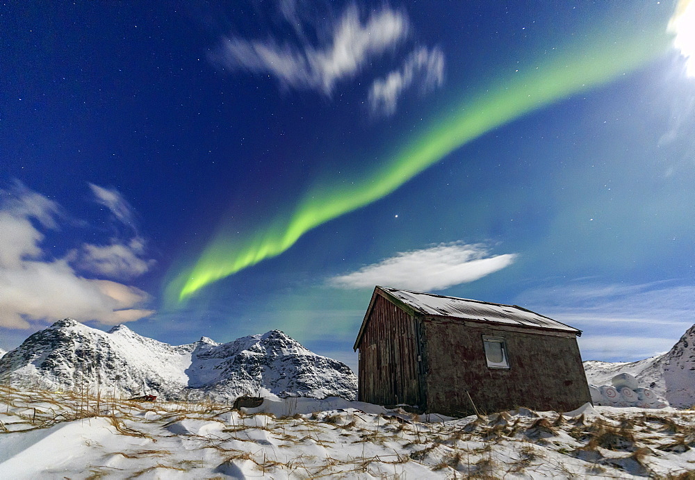 Northern Lights (aurora borealis) over a small wooden house. Flakstad, Lofoten Islands, Arctic, Norway, Scandinavia, Europe