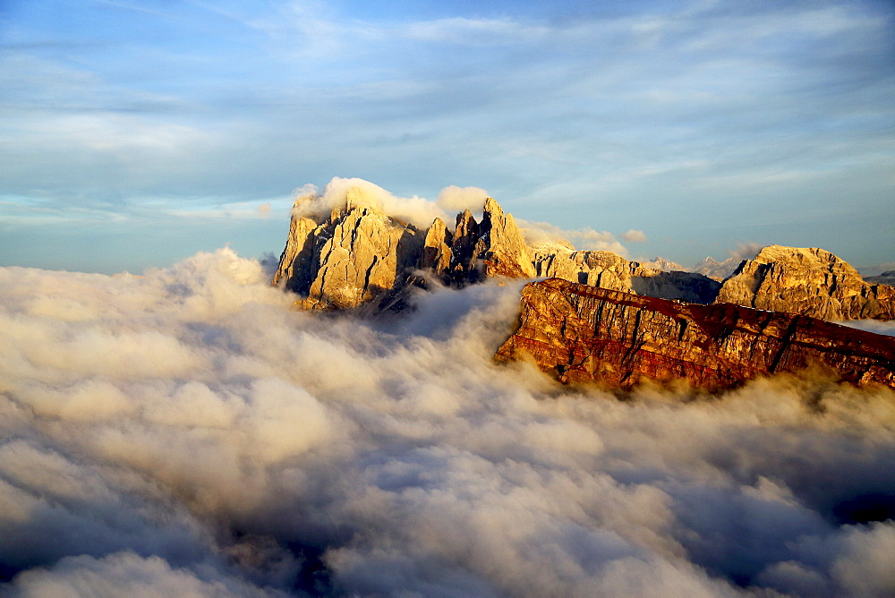 Aerial shot from Seceda of Odle surrounded by clouds at sunset in the Dolomites, Val Funes, Trentino-Alto Adige South Tyrol, Italy, Europe