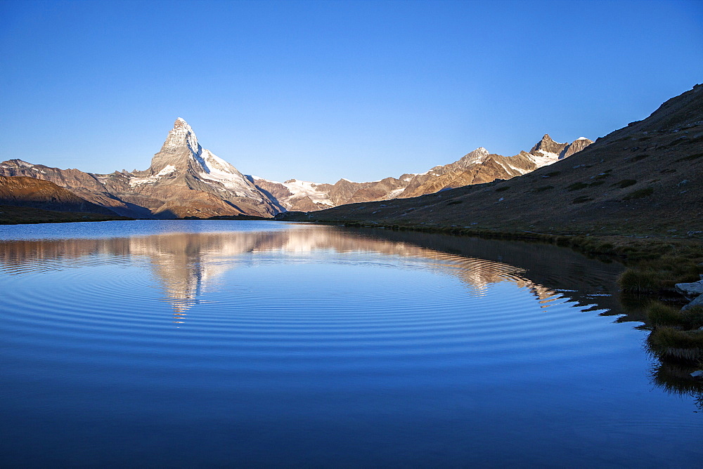 The Matterhorn reflected in Stellisee at sunrise, Zermatt, Canton of Valais, Pennine Alps, Swiss Alps, Switzerland, Europe