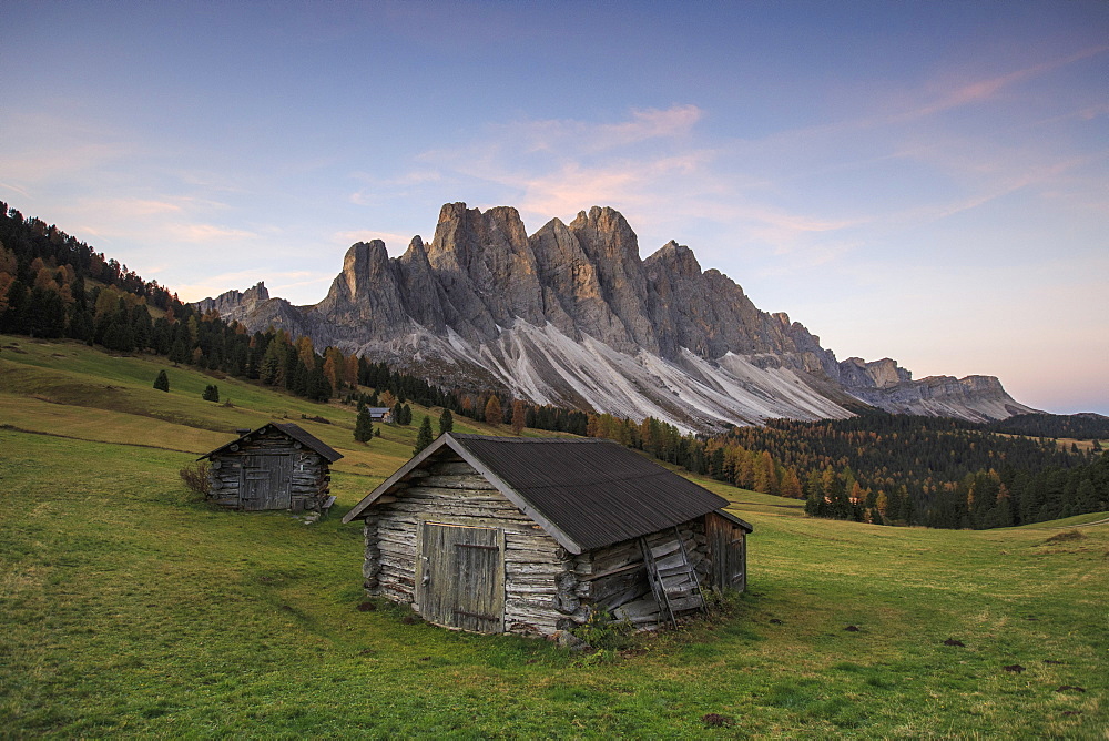 The early morning light illuminates Malga Zannes and the Odle in background, Funes Valley, South Tyrol, Dolomites, Italy, Europe