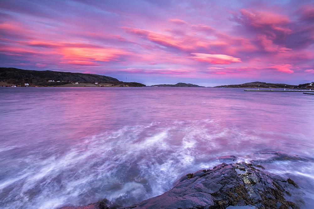 Pink sky at sunrise reflected in the cold waters, Flatanger, Trondelag, Norway, Scandinavia, Europe