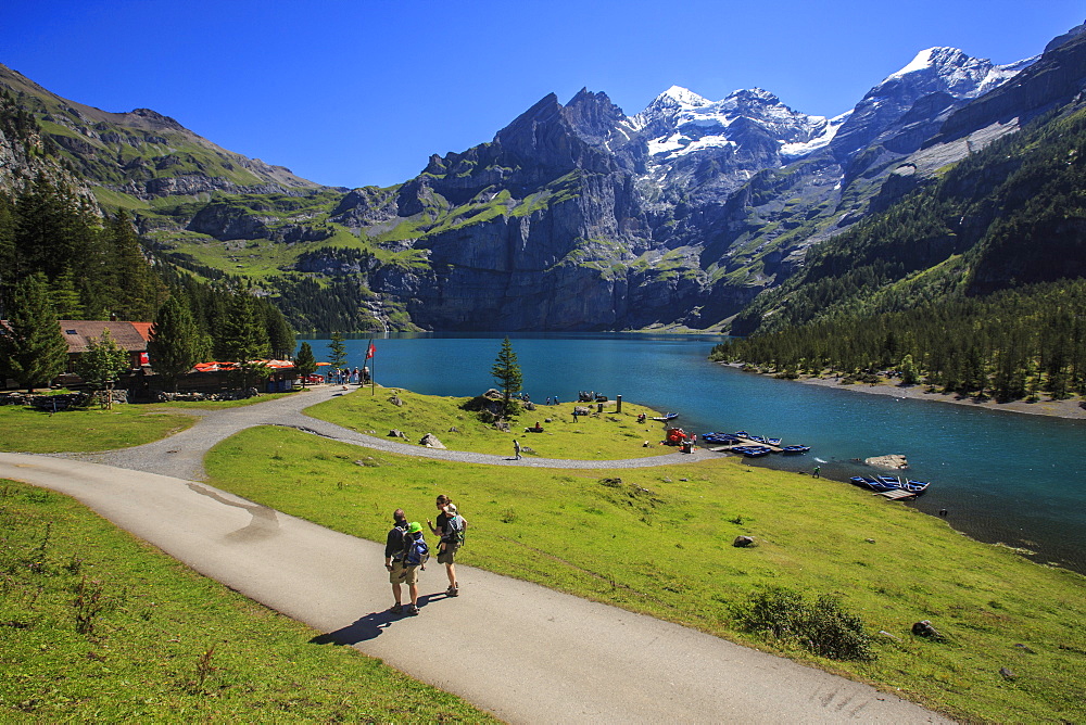 Hikers around Lake Oeschinensee, Bernese Oberland, Kandersteg, Canton of Bern, Switzerland, Europe