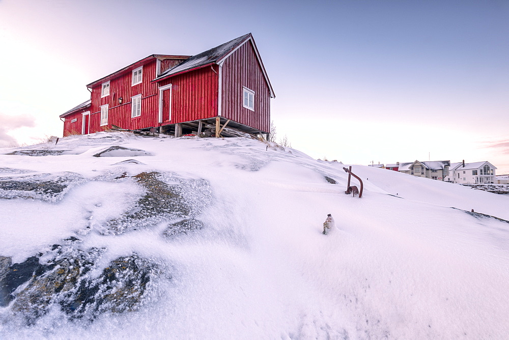 Pink sky on the typical red house of fishermen (rorbu), Henningsvaer, Lofoten Islands, Arctic, Northern Norway, Scandinavia, Europe