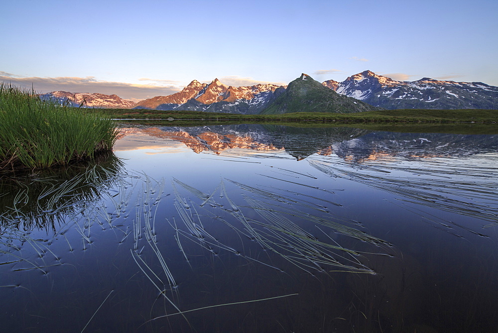 Mount Cardine and Peak Tambo are reflected in Lake Andossi at sunrise, Chiavenna Valley, Valtellina, Lombardy, Italy, Europe