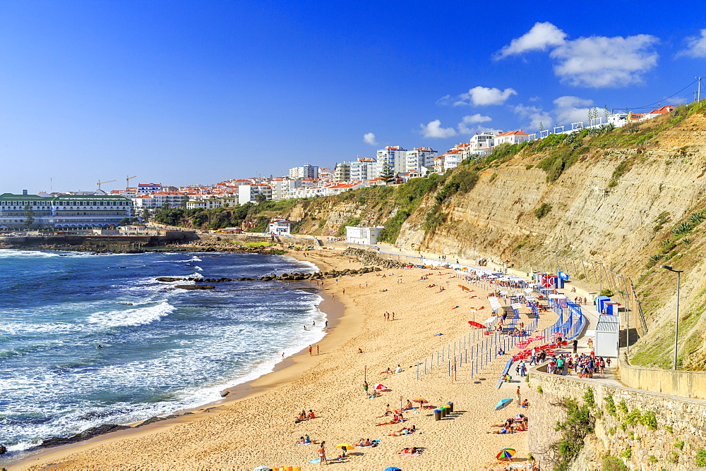 Top view of the village of Ericeira with the ocean waves crashing on the touristic sandy beach, Mafra, Portugal, Europe