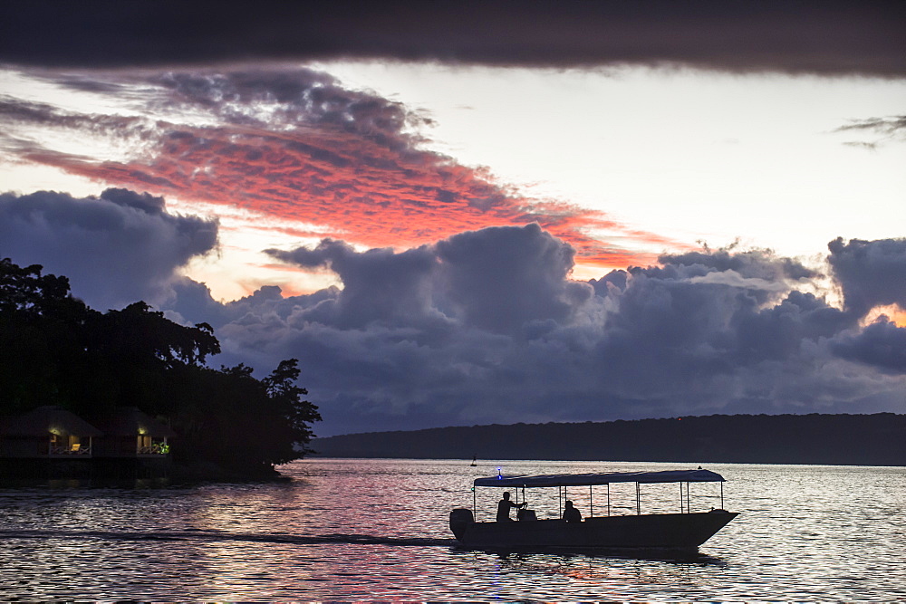 Tourist boat driving back home at sunset in Port Vila, Efate, Vanuatu, Pacific