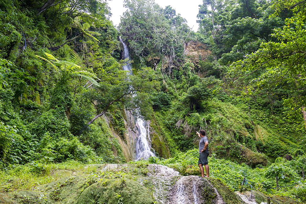 Man standing underneath the Mele Cascades, Efate, Vanuatu, Pacific