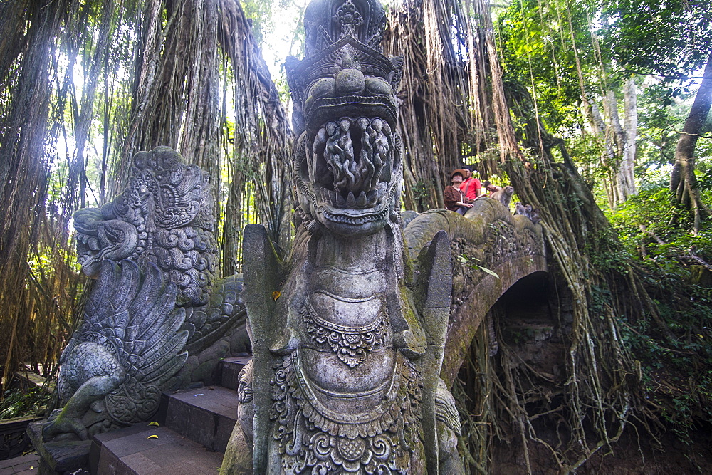 Very beautiful carved bridge with overgrowing trees, Sacred Monkey Forest Sanctuary, Ubud, Bali, Indonesia, Southeast Asia, Asia