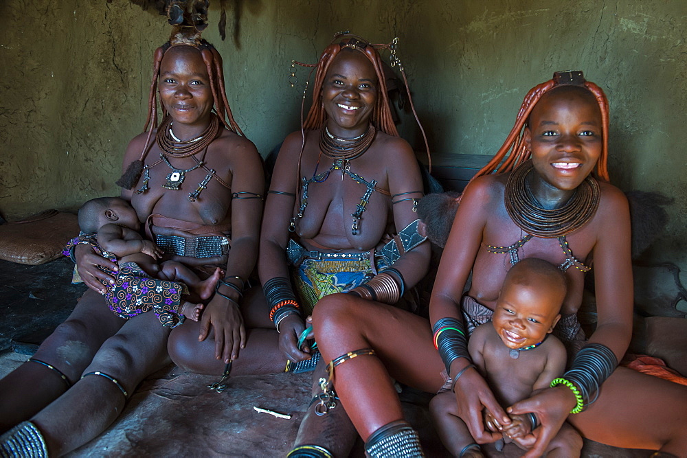 Friendly Himba women in their hut, Kaokoland, Namibia, Africa