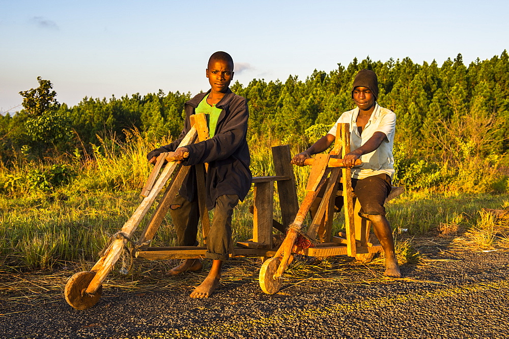 Local boys on their self-made bicycles, Malawi, Africa