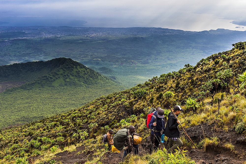 Trekkers on the steep slopes of Mount Nyiragongo, Virunga National Park, Democratic Republic of the Congo, Africa