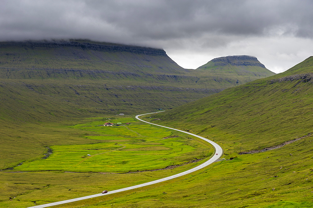 Long winding road through the Fjordland of Estuyroy, Faroe Islands, Denmark, Europe