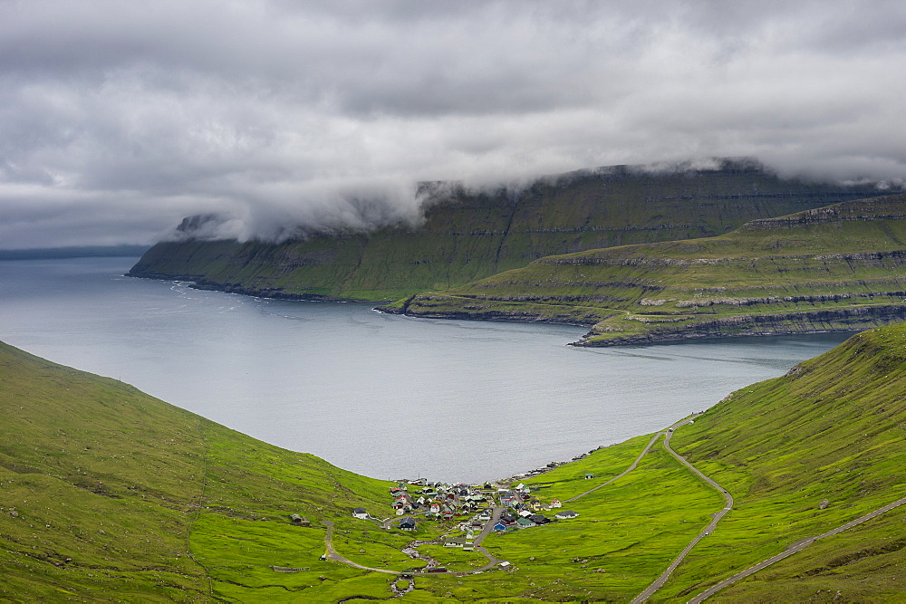 Little village of Funnigur in a huge fjord, Estuyroy, Faroe Islands, Denmark, Europe