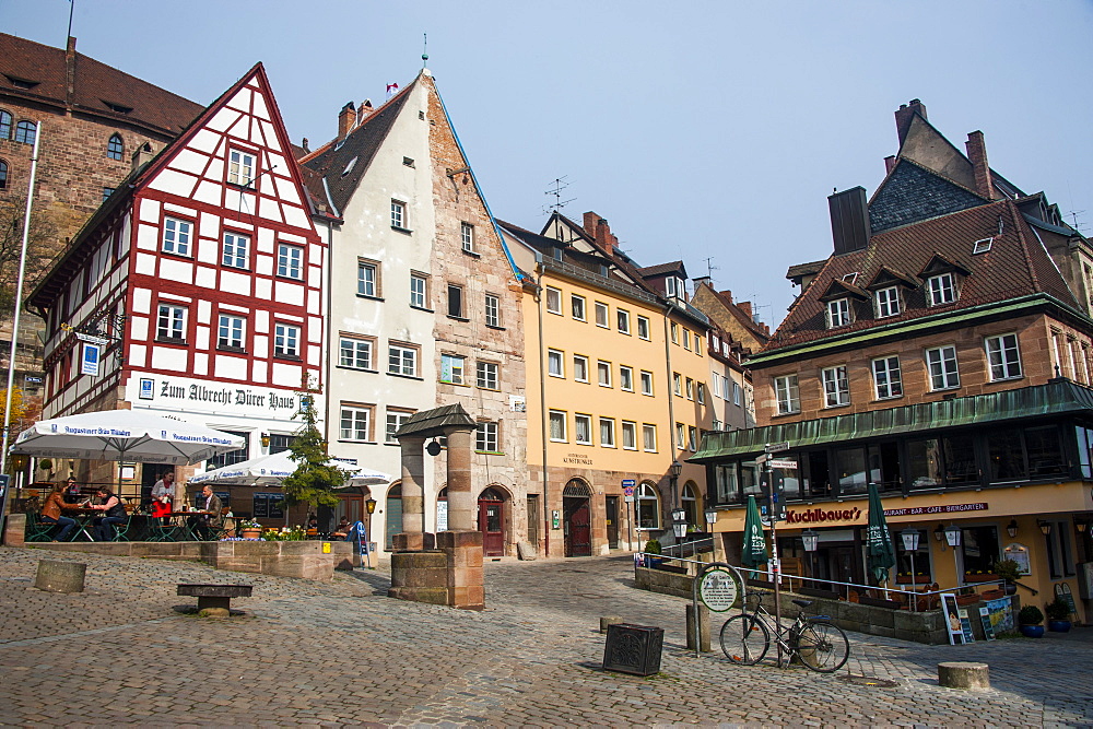 Half timbered houses and open air cafes on Albrecht Duerer square in the medieval town center of the town of Nuremberg, Bavaria, Germany, Europe