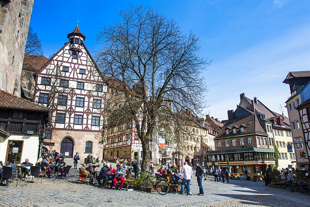 Half timbered houses and open air cafes on Albrecht Duerer square in the medieval town center of the town of Nuremberg, Bavaria, Germany, Europe