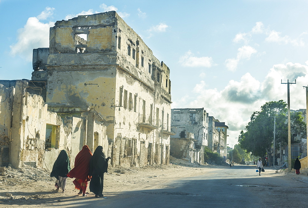 Somali women walking through the streets of the destroyed houses of Mogadishu, Somalia, Africa