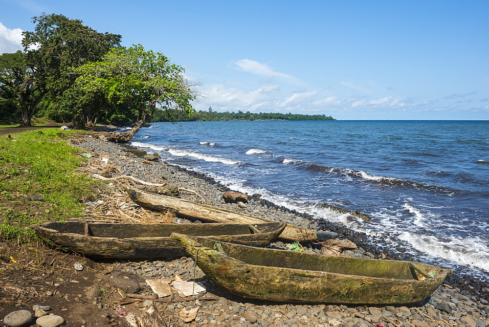 Wooden canoes on the rocky coast of the island of Bioko, Equatorial Guinea, Africa