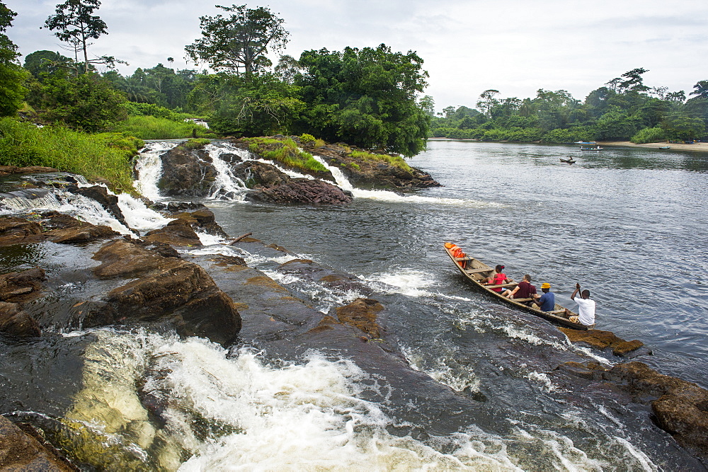 Tourist boat below the Lobe waterfalls, Kribi, Cameroon, Africa