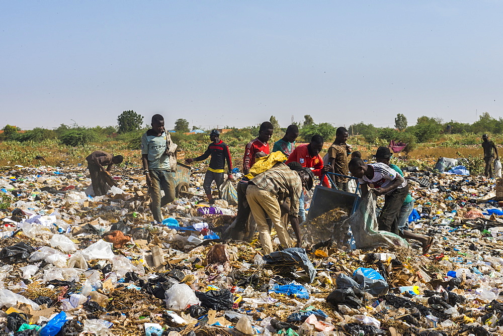 Local boys looking for valuables in the public rubbish dump, Niamey, Niger, Africa