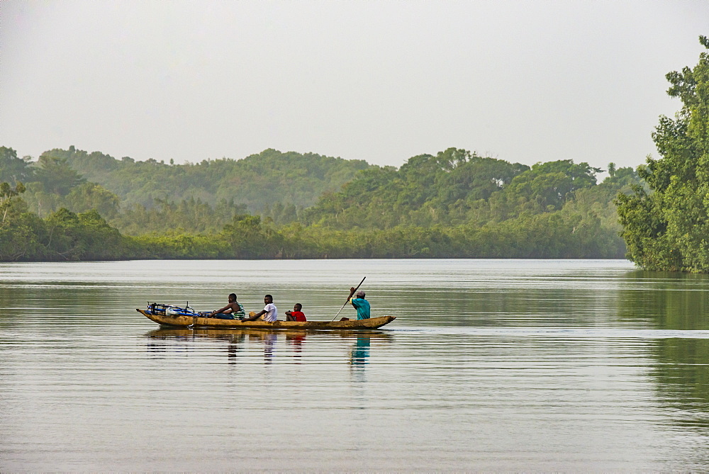 Locals in a canoe on a river east of Buchanan, Liberia, West Africa, Africa