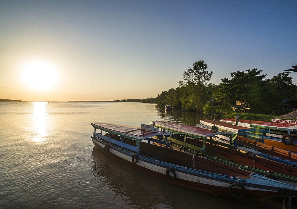 Fishing boats at sunset on the Suriname River near Paramaribo, Surinam, South America