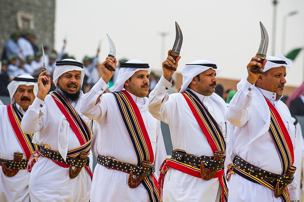 Traditional dressed local tribesmen dancing at the Al Janadriyah Festival, Riyadh, Saudi Arabia, Middle East