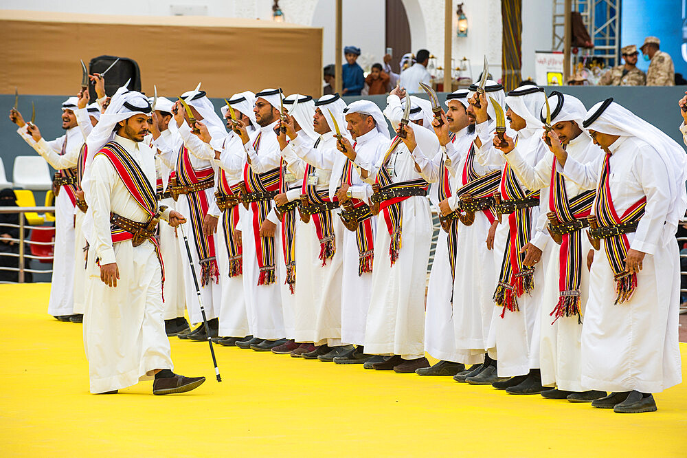 Traditional dressed local tribesmen dancing at the Al Janadriyah Festival, Riyadh, Saudi Arabia, Middle East