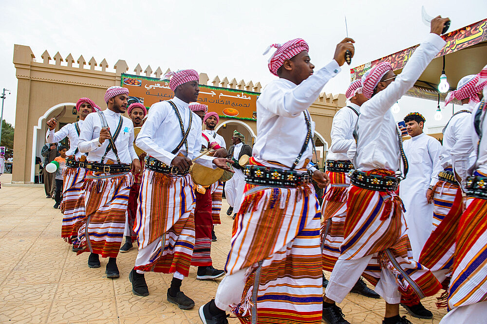 Traditional dressed local tribesmen dancing at the Al Janadriyah Festival, Riyadh, Saudi Arabia, Middle East