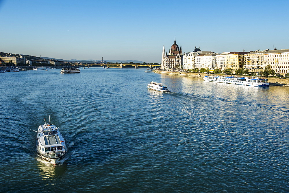 Little ferries on the River Danube in front of the Panorama of Pest, Budapest, Hungary, Europe