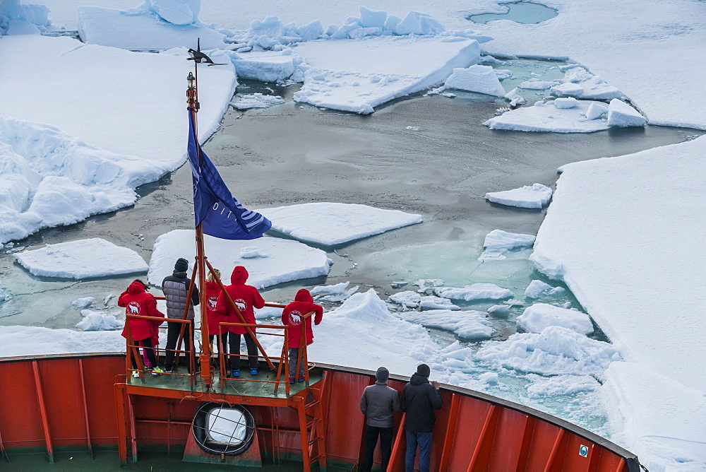 Tourists watching the ice breaking on board of an icebreaker, North Pole, Arctic