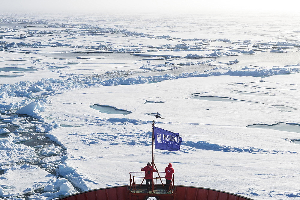 People enjoying the breaking ice on board of an icebreaker, North Pole, Arctic