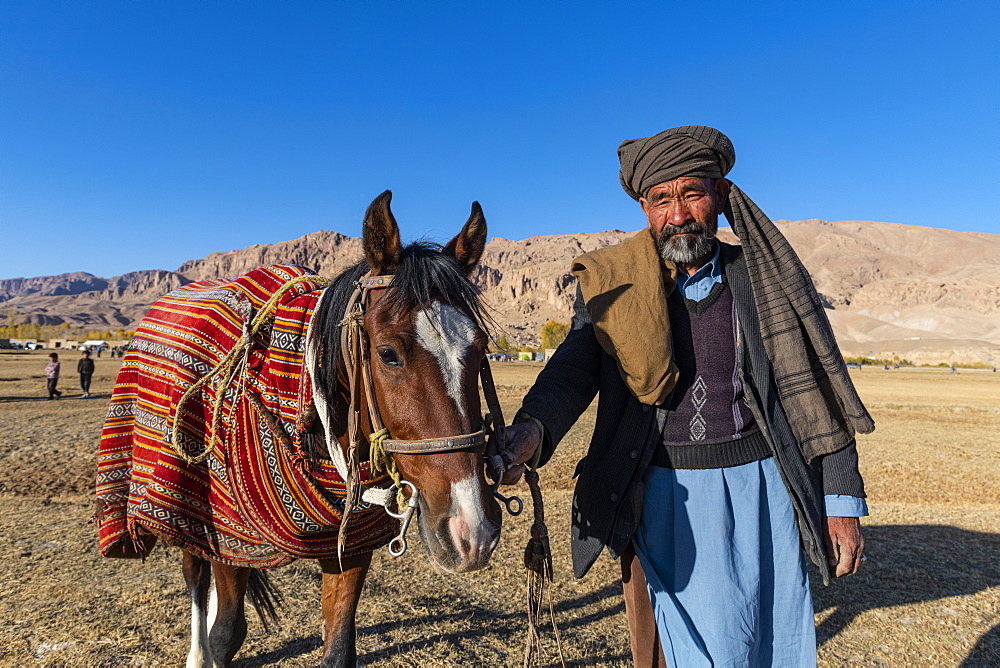 Old man with his horse at a Buzkashi game, Yaklawang, Afghanistan, Asia