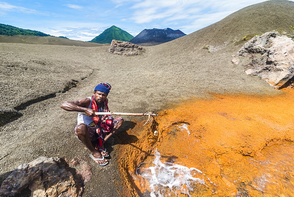 Man boiling Megapode eggs in a sulphur stream of Volcano Tavurvur, Rabaul, East New Britain, Papua New Guinea, Pacific