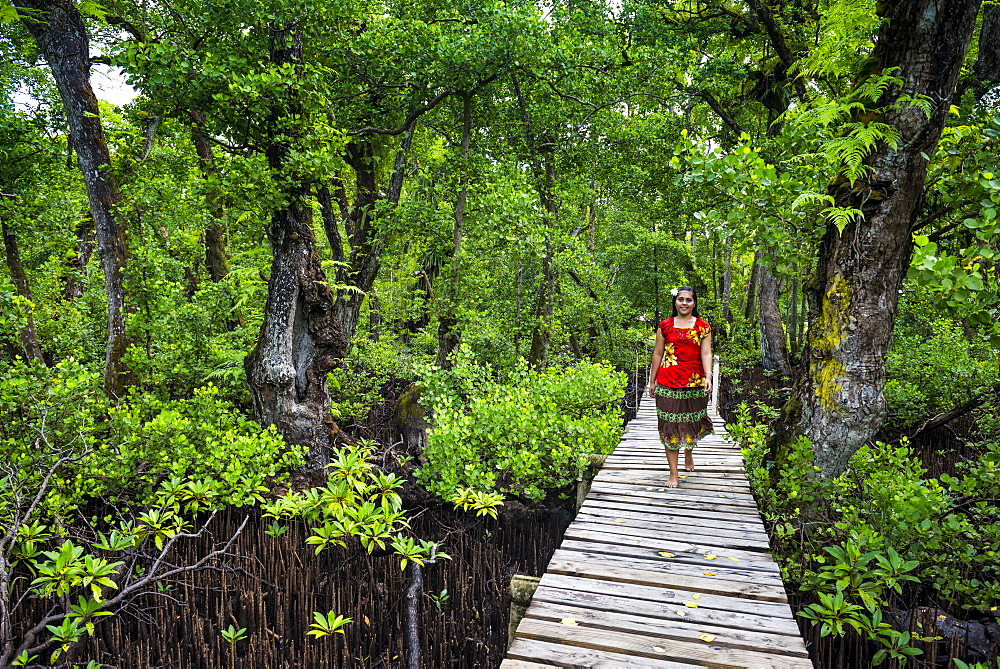 Local girl walking along a long wooden pier, Kosrae, Federated States of Micronesia, South Pacific