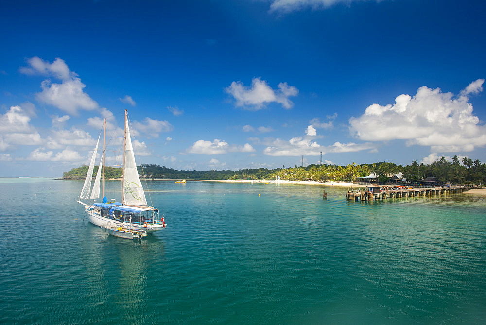 Sailing boat anchoring on Mana Island, Mamanuca Islands, Fiji, South Pacific