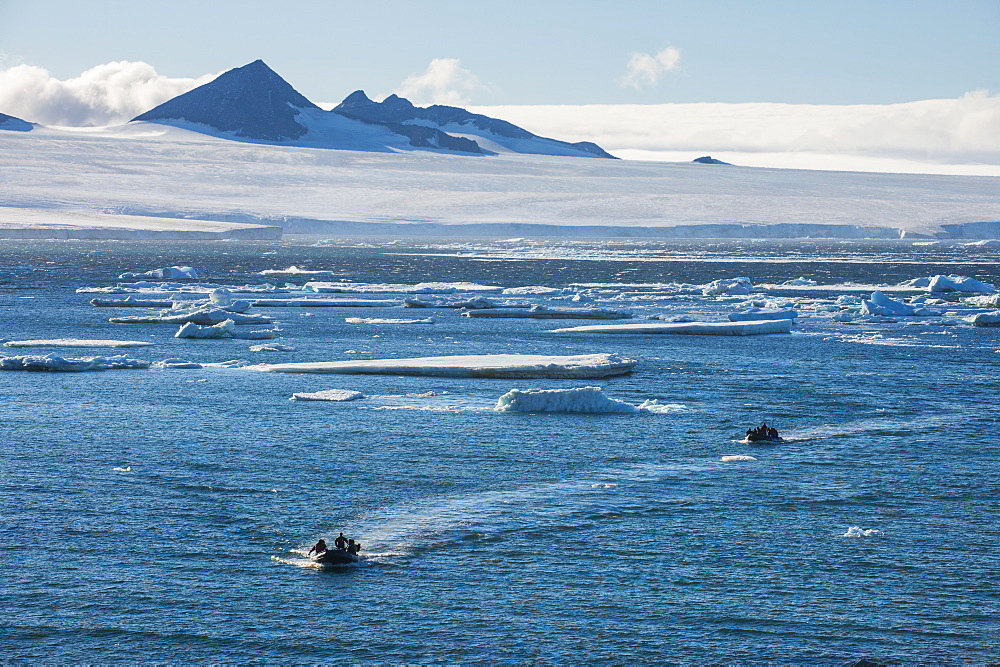 Zodiac with tourists cruising through the icebergs, Brown Bluff, Tabarin Peninsula, Antarctica, Polar Regions