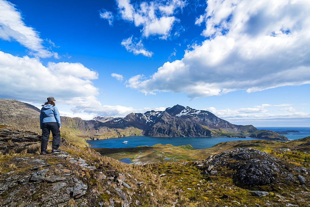 Tourists admiring the stunning scenery of Godthul, South Georgia, Antarctica, Polar Regions