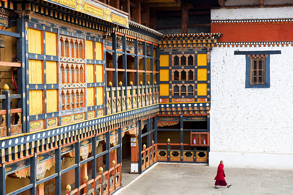 Monk walking through Rinpung Dzong, Paro District, Bhutan, Asia