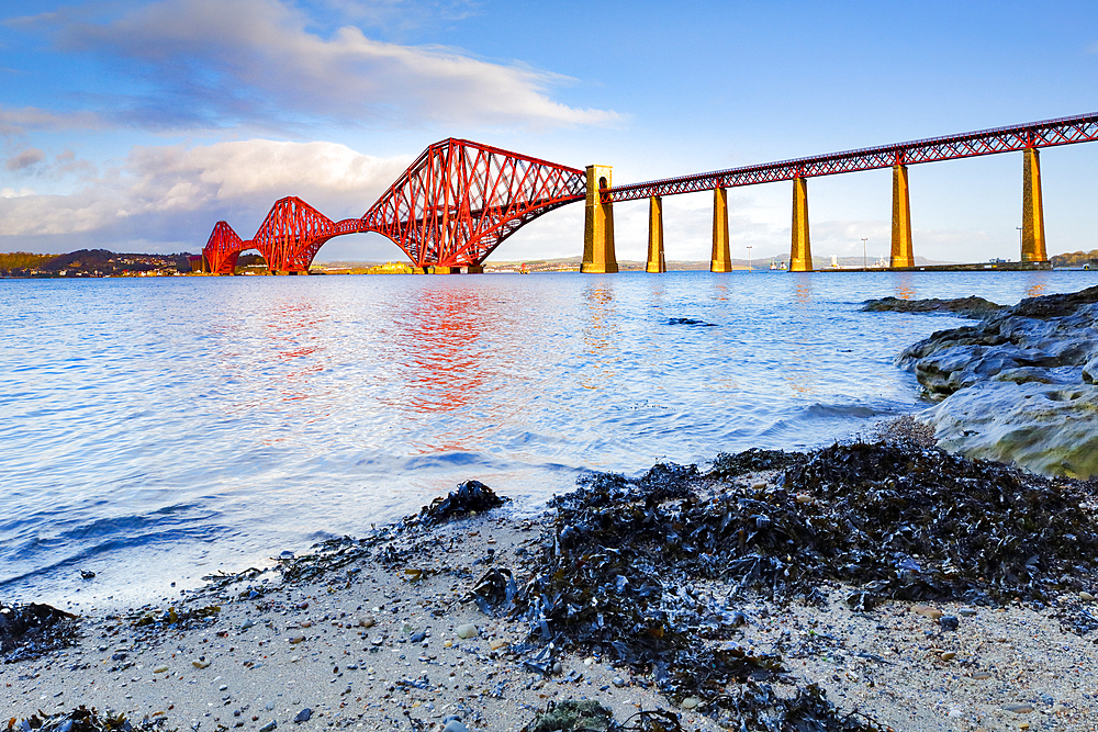 Brilliant red Forth Bridge railway crossing, UNESCO World Heritage Site, at the Fírth of Forth in South Queensferry, near Edinburgh, Scotland, United Kingdom, Europe