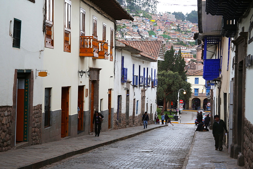 Side street in centre of Cusco City with outskirts of city on hill beyond, Cuzco, Peru, South America