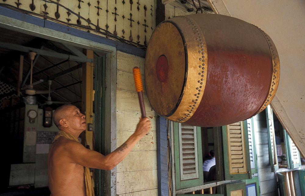 Thailand monk beating drum, wat prok, bangkok