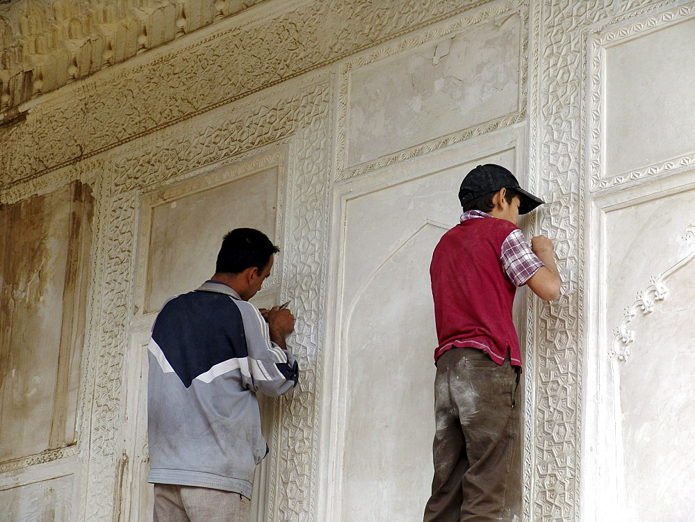 Uzbekistan craftsman and apprentice repairing the shah-i-zinda necropolis of mausoleums, samarkand