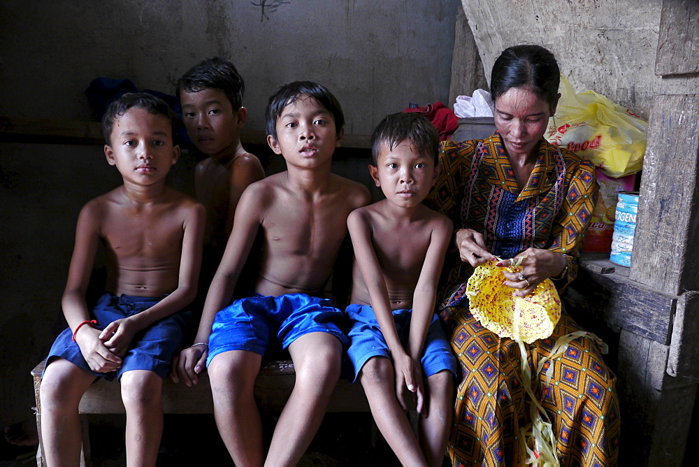 CAMBODIA Khoun Sokhoun, 44, former garbage scavenger, now maker of hats from recycled plastic bags and other items from recycled paper, benefciary of project run by local NGO CSARO which works with waste collectors in Phnom Penh. Seen here with her sons and orphaned nephews