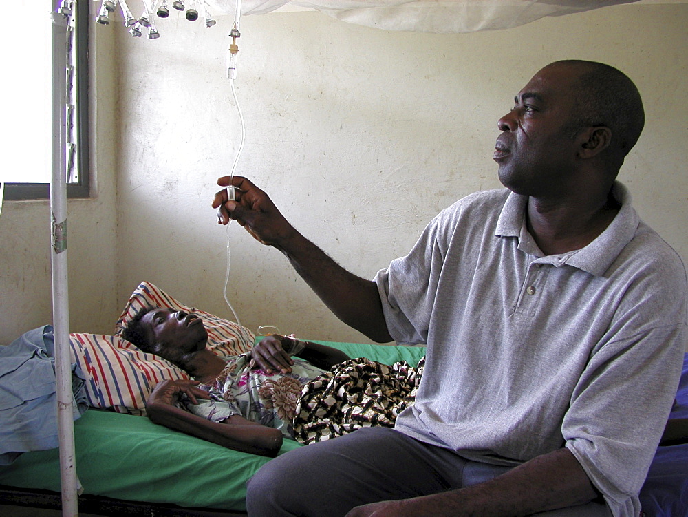 Ghana idi adama (), nurse visiting abiba zakariah who is blind and hiv+ at sheikhanah clinic, tamale