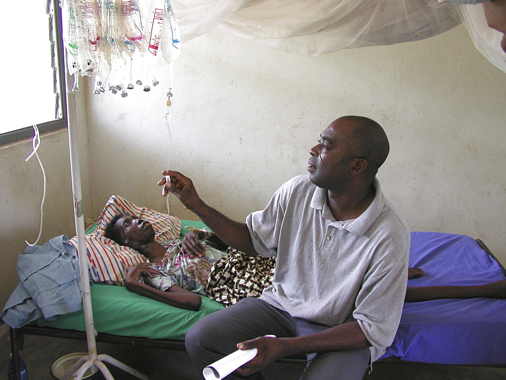 Ghana idi adama (), nurse visiting abiba zakariah who is blind and hiv+ at sheikhanah clinic, tamale