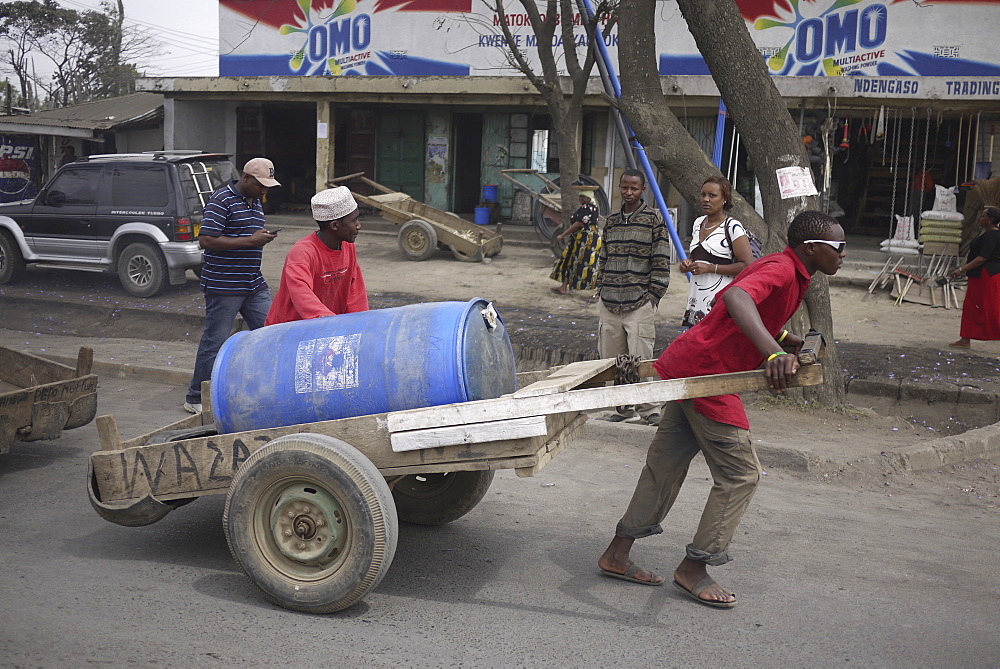 TANZANIA Man hauling a load of water, Arusha. photograph by Sean Sprague