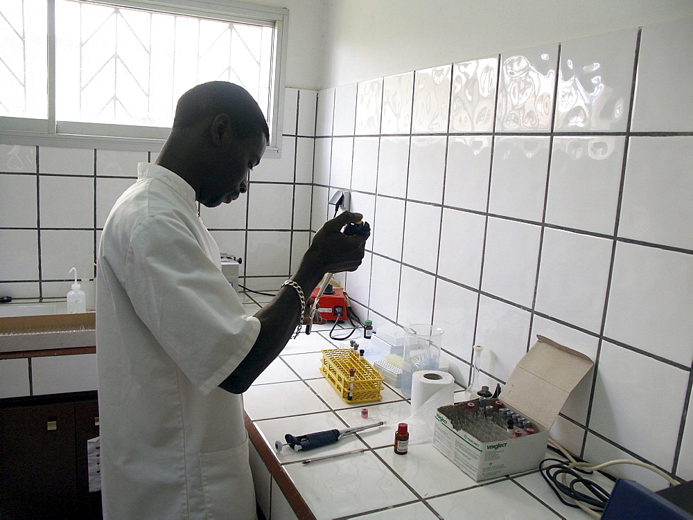 Senegal lab technician andre nghaye testing blood samples for hiv virus service cnter, dakar