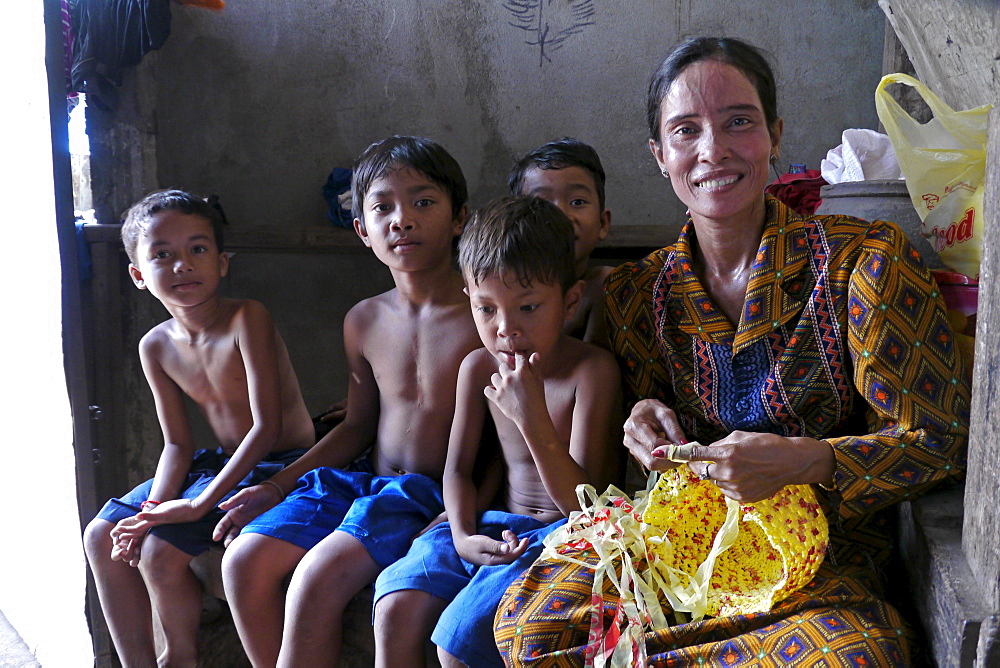 CAMBODIA Khoun Sokhoun, 44, former garbage scavenger, now maker of hats from recycled plastic bags and other items from recycled paper, benefciary of project run by local NGO CSARO which works with waste collectors in Phnom Penh. Seen here with her sons and orphaned nephews