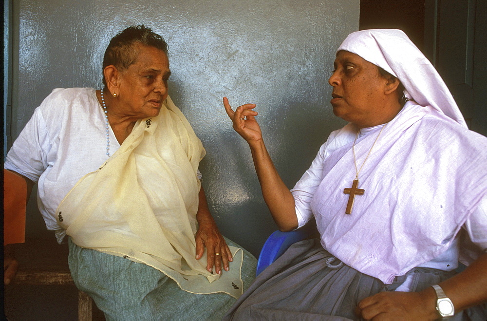 India catholic talking to woman at old peoples, trichur, kerala