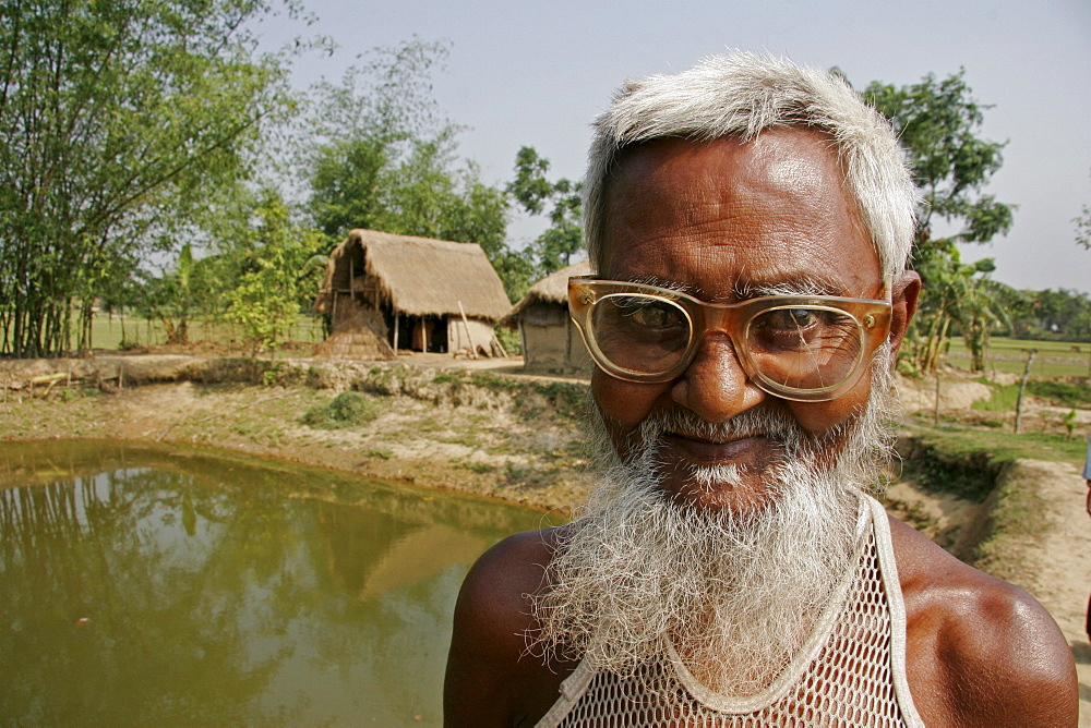 Bangladesh farmer with fish pond, kumargati village, mymensingh region